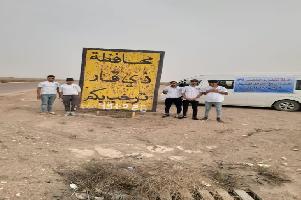 خوێندکاران و لاوانی نەسڕ سەبەتە خۆراکییەکە لە گەڕەکەکانی پارێزگای زیقاردا دابەش دەکەن